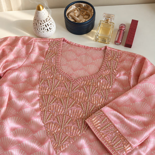 Blush laid flat, showing the pink fan print and sequinned fan-motif neckline panel