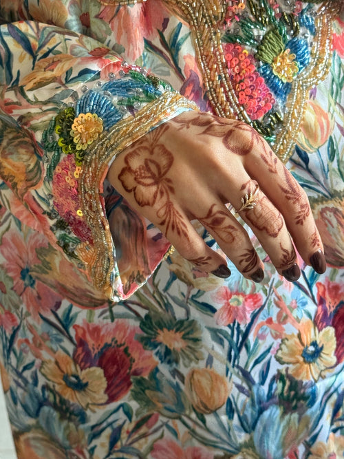 Close-up of the Eden cuff with gold beadwork and sequinned flowers